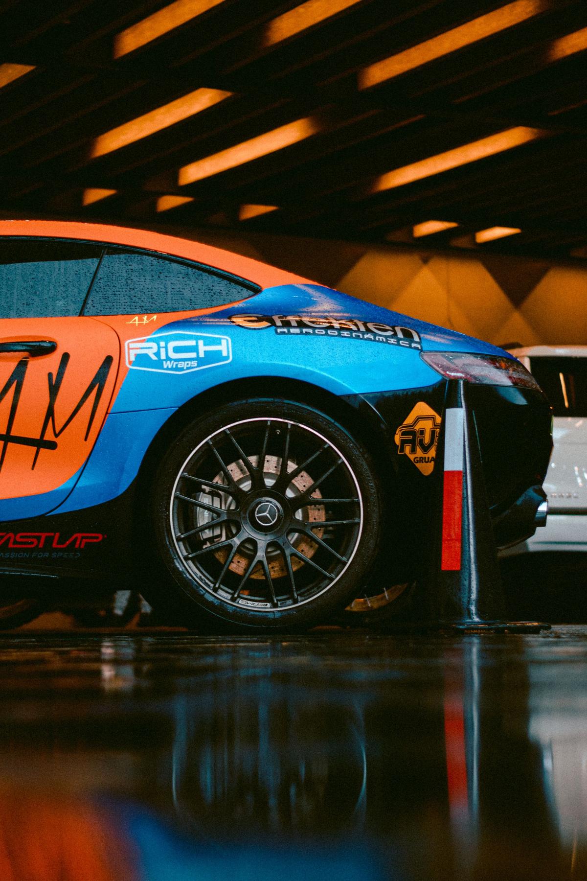 Printed blue and orange racing livery on a sports car