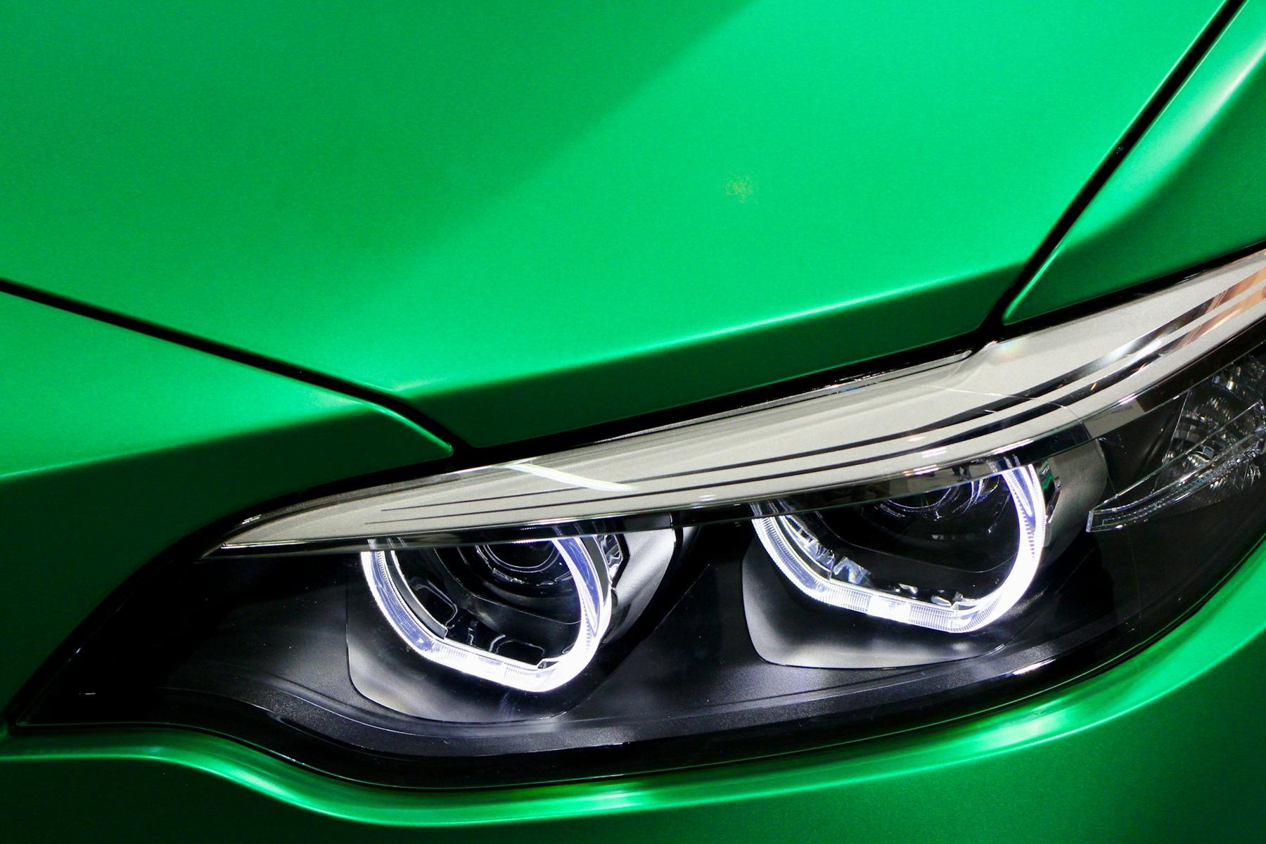 Close-up of a color-shift green wrap around a headlight